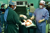 Removing a massive tumor located in the patients leg by Dr. Qahemi and his team of surgeons